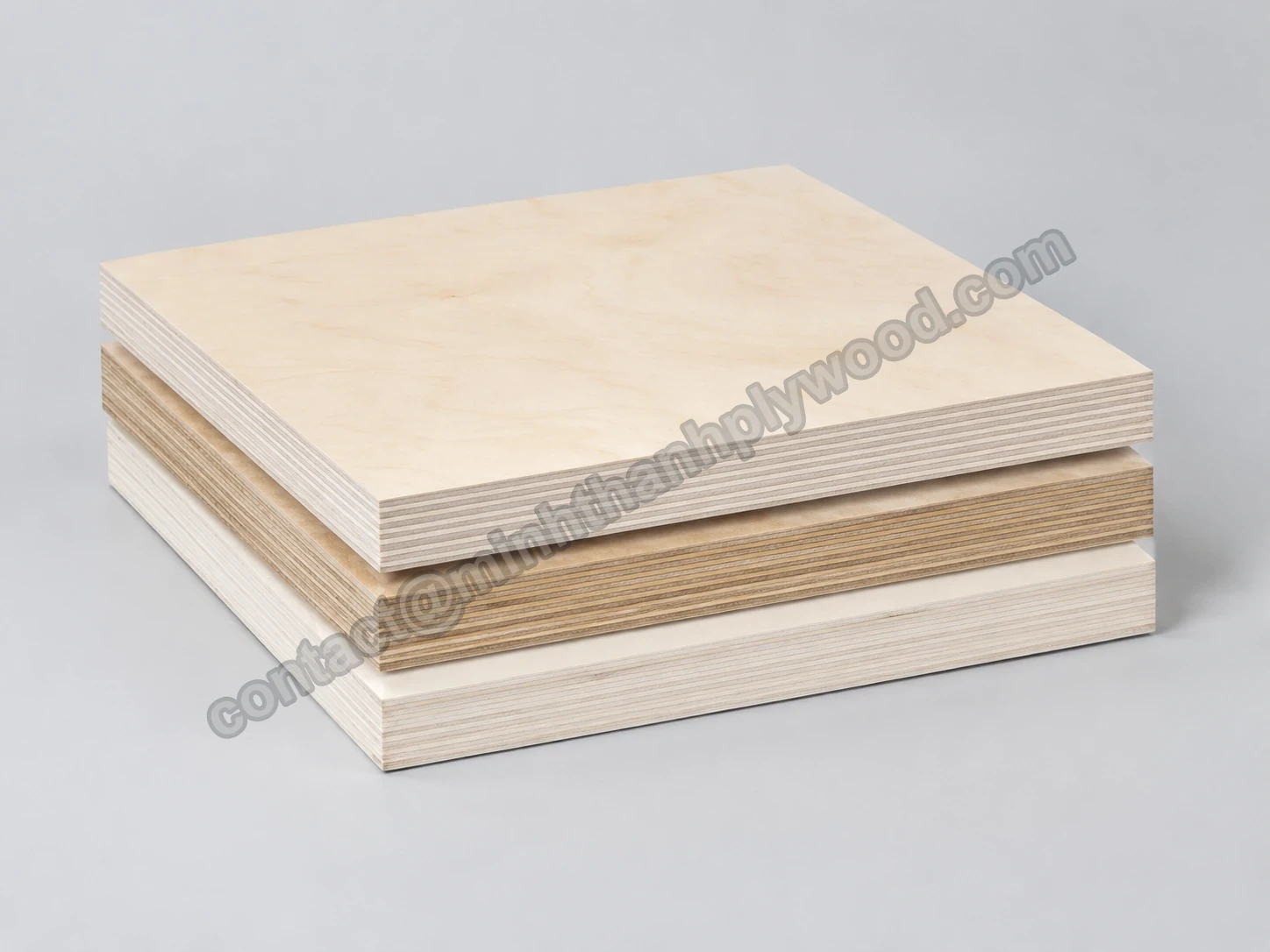 Three plywood panels stacked to compare a birch face and three different layered cores