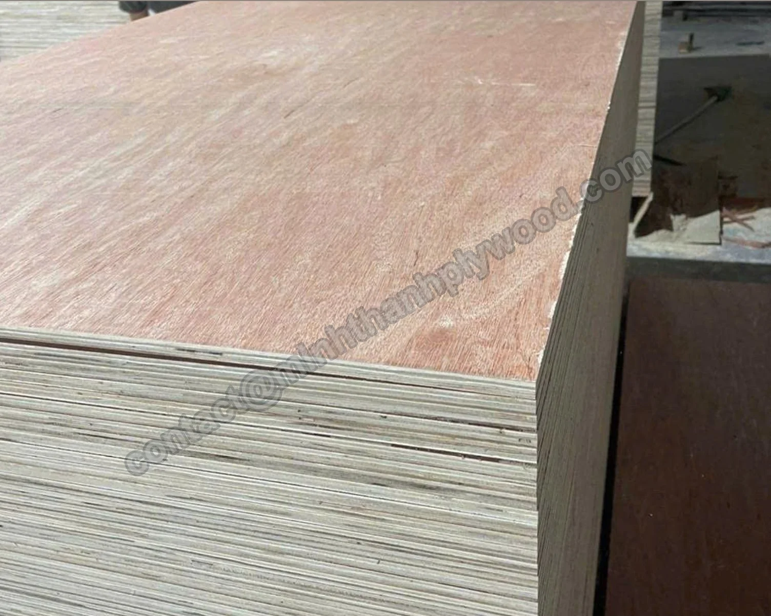 Red-brown bintangor-faced plywood panel on a tall stack