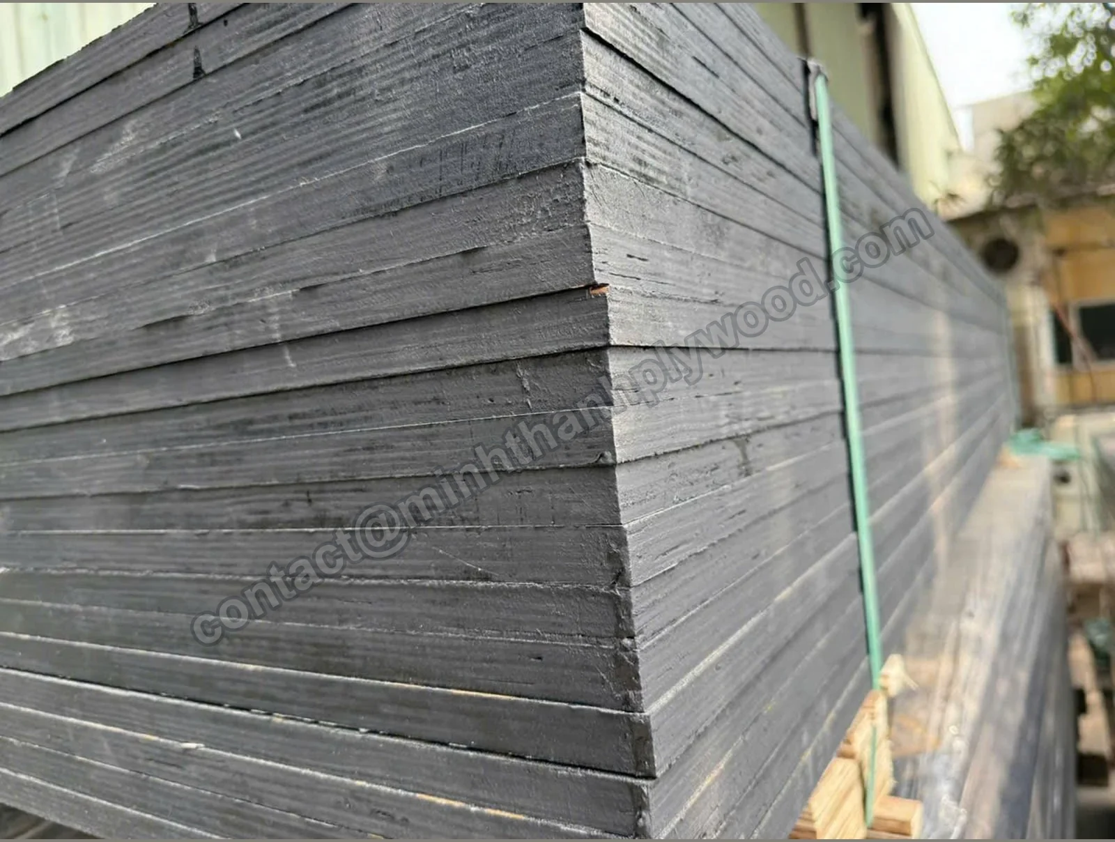 Painted edges of a strapped film-faced plywood stack