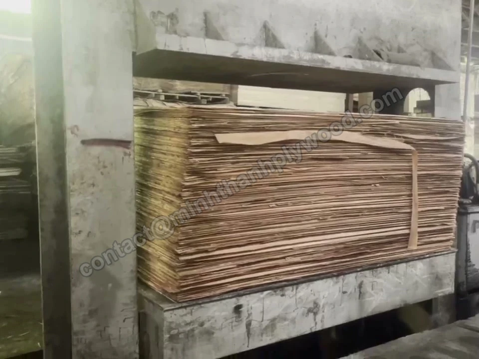 Stack of glued plywood cores in a cold pre-press before hot pressing