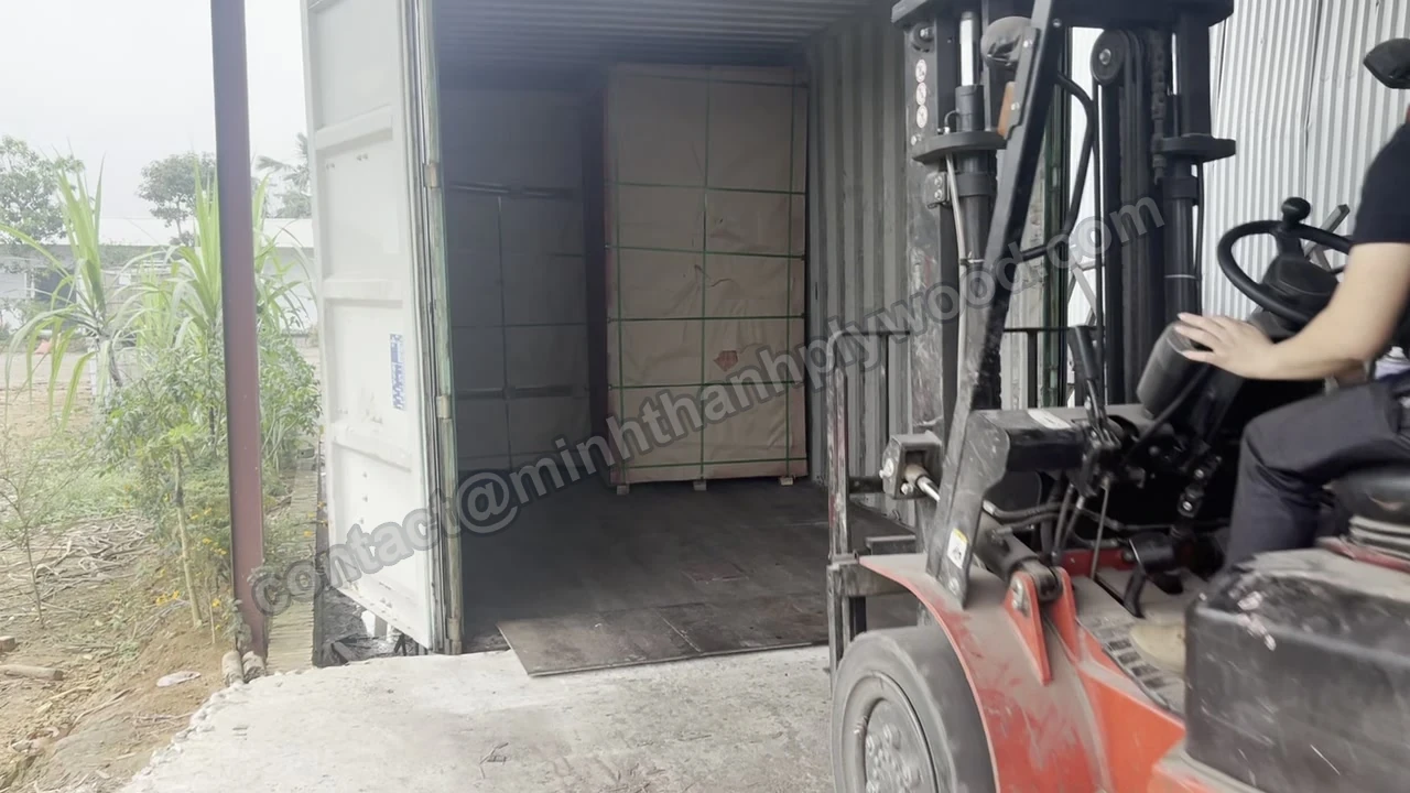 Plywood pack standing upright at the door end of a container as the forklift reverses out