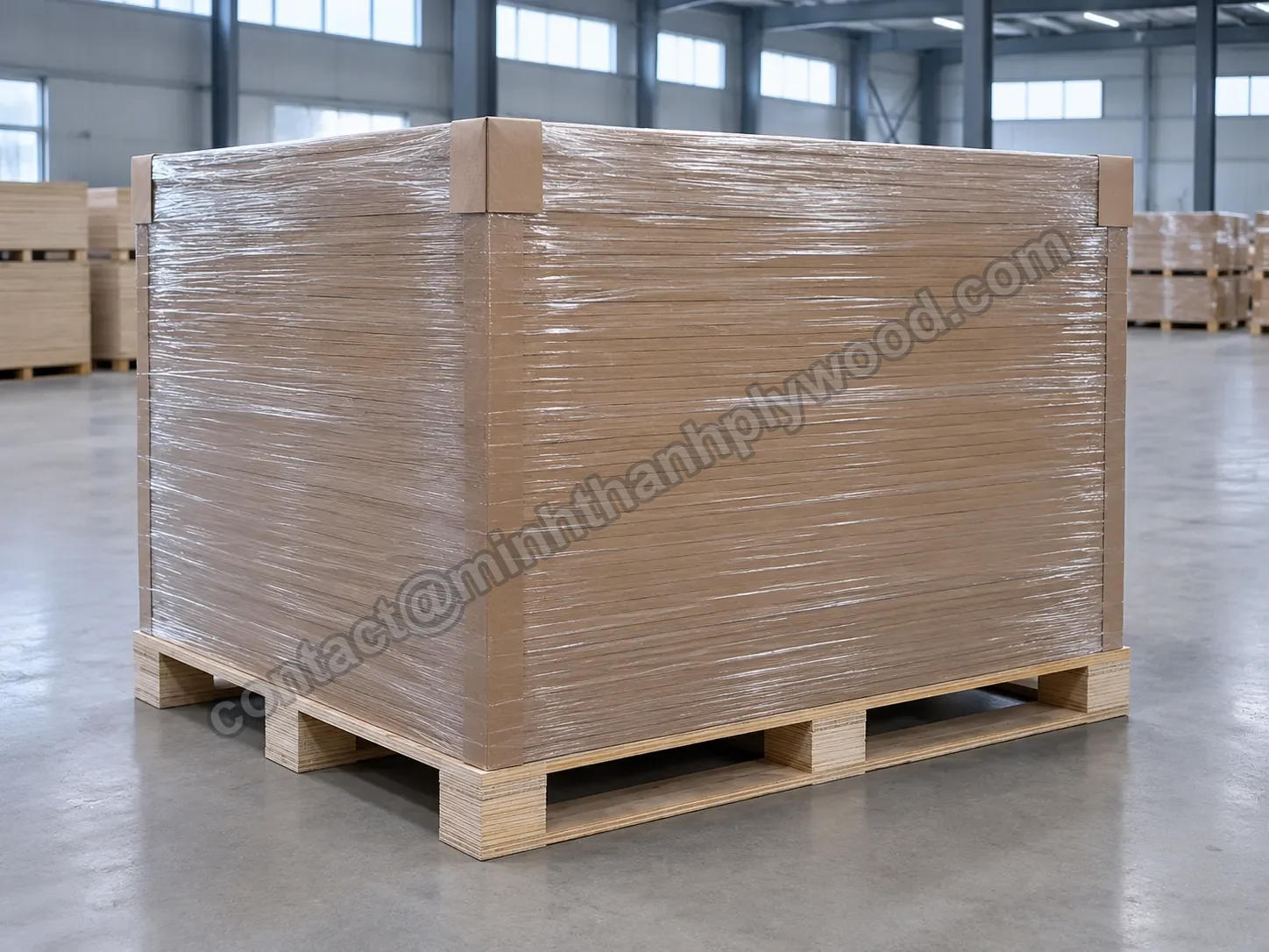 Plywood export pack wrapped in clear plastic film over kraft cardboard on a pallet