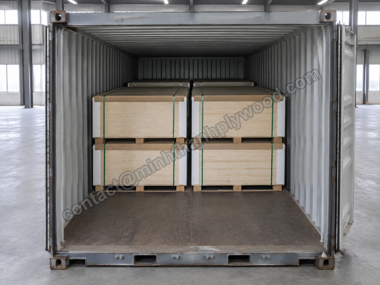 Plywood packs lying two-high and two across inside a 40HC container, near half of the floor still empty