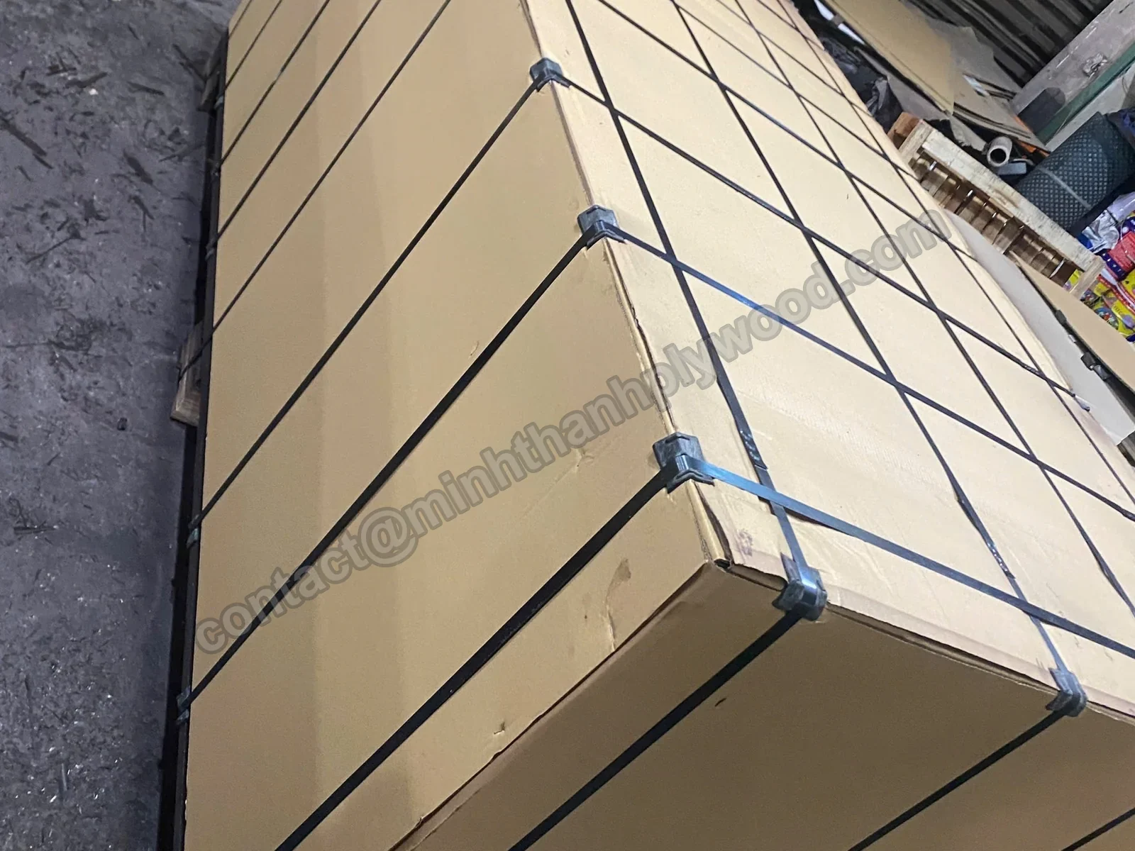 Plywood export pack covered in cardboard and strapped with steel bands